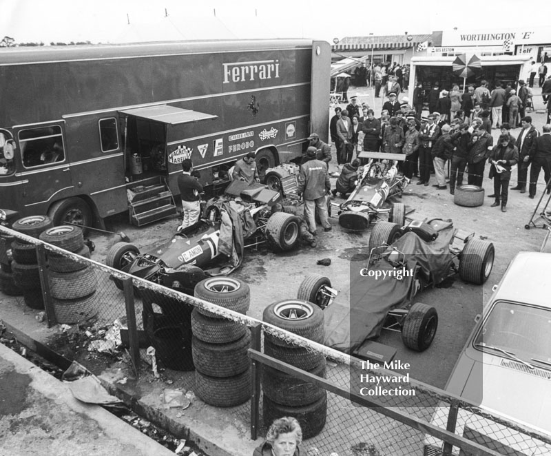 Ferrari mechanics working on Chris Amon and Pedro Rodriguez's 312 V8's in the paddock, Silverstone, British Grand Prix 1969.
