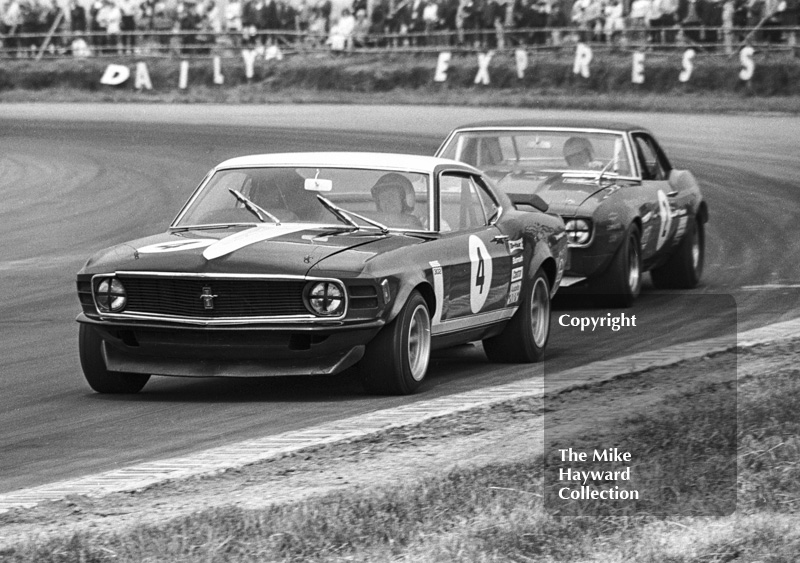 Winner Brian Muir, Wiggins Teape Chevrolet Camaro, chases Frank Gardner, Motor Racing Research Ford Mustang Boss, out of Copse Corner, Silverstone Martini Trophy meeting 1970.
