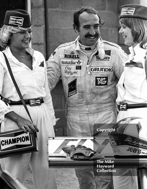 Clay Regazzoni with two champion young ladies, Silverstone, British Grand Prix 1979.
