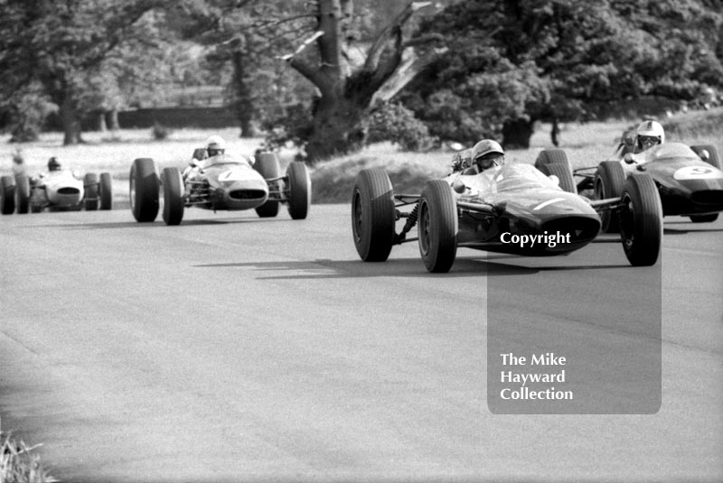 Denny Hulme, Brabham BT16, glances over at John Surtees, Lola T60, as they battle for the lead, Oulton Park Gold Cup, 1965
