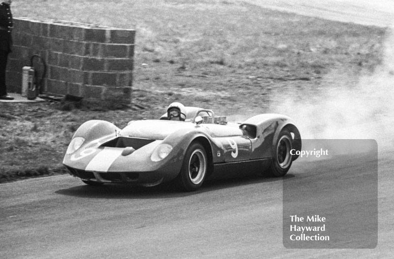 Bruce McLaren, McLaren Oldsmobile, trailing smoke from a broken automatic transmission oil seal, Tourist Trophy, Oulton Park, 1965.
