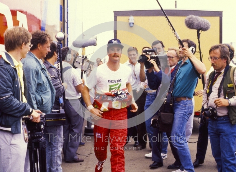 Nigel Mansell runs through the paddock, British Grand Prix, Silverstone, 1987
