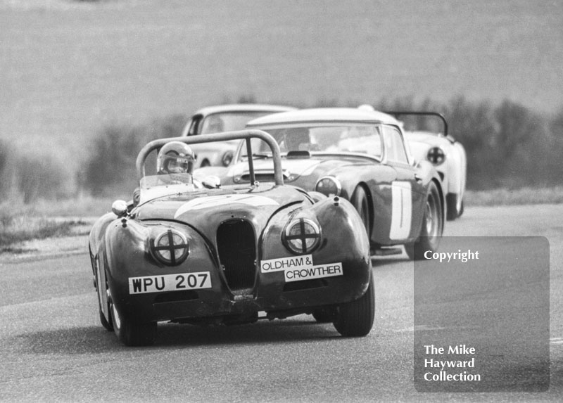 David Preece, Jaguar XK120 (WPU 207), leads John Chatham, Austin Healey 100/6,&nbsp;through the chicane, Philips Car Radio Thoroughbred Sports Car race, F2 International meeting, Thruxton, 1977.
