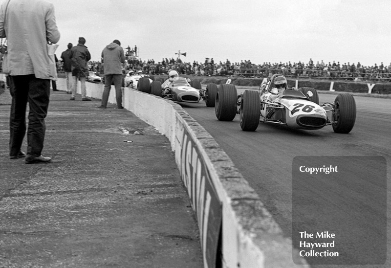 Ronnie Peterson, Tecno 69, followed by Tim Schenken, Brabham BT28, Silverstone, 1969 British Grand Prix meeting.
