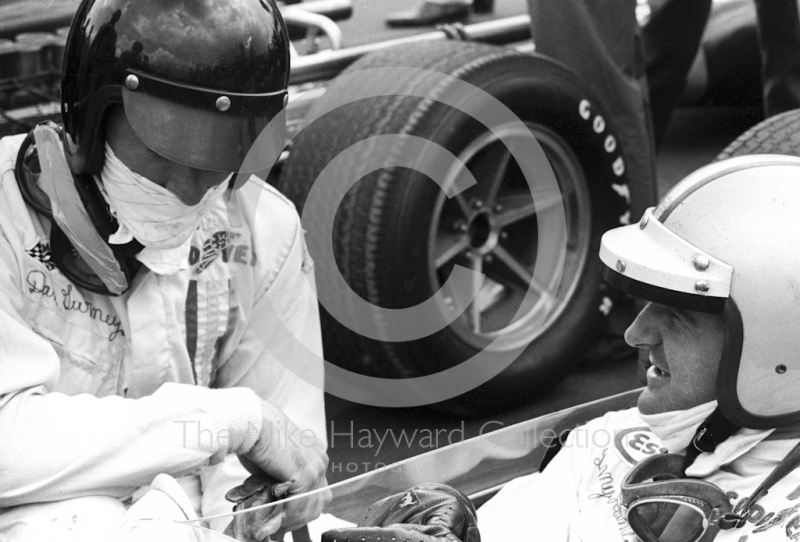 Dan Gurney, left, chats to Denny Hulme on the grid at Silverstone before the start of the 1967 British Grand Prix.
