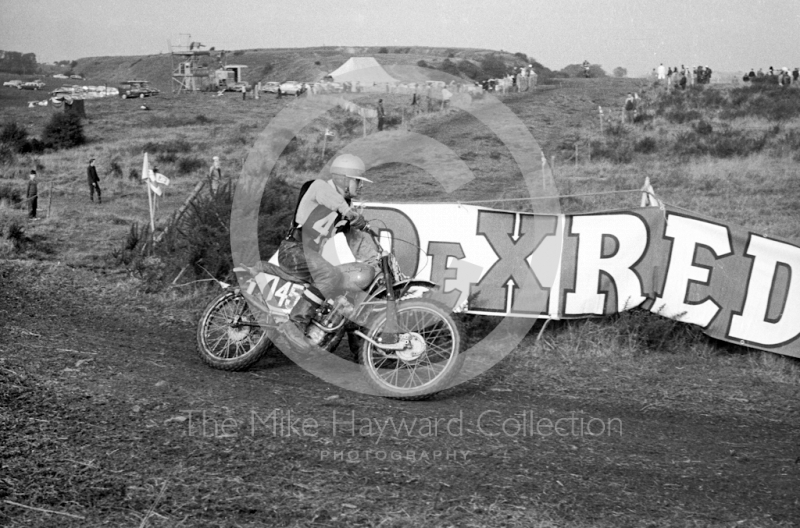 Racing on the pit mounds, motorcycle scramble at Spout Farm, Malinslee, Telford, Shropshire between 1962-1965