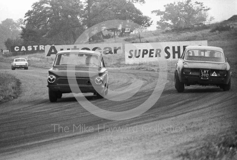 Geoff Breakell, Alfa Romeo GTA, LWY 39D, heading for 5th place in Class A, leads a Lotus Cortina out of Cascades, Oulton Park Gold Cup meeting, 1967.
