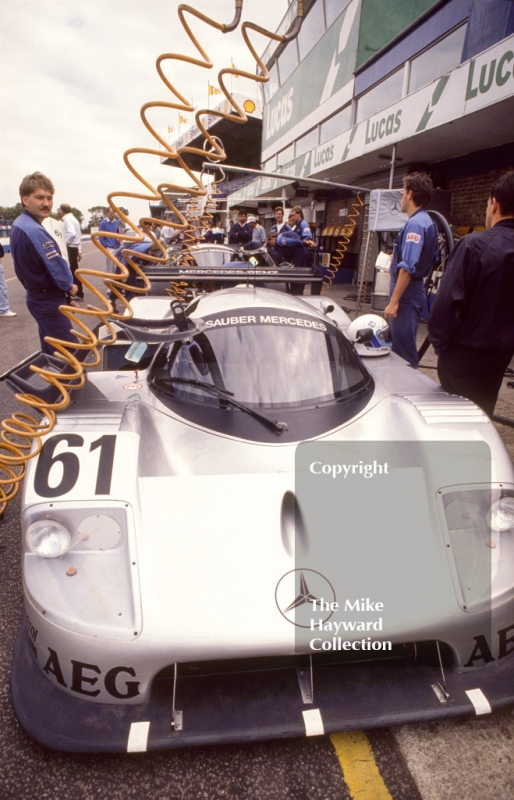 Mechanics work on the Sauber Mercedes C9/88 of Mauro Baldi and Kenny Acheson, Wheatcroft Gold Cup, Donington Park, 1989.
