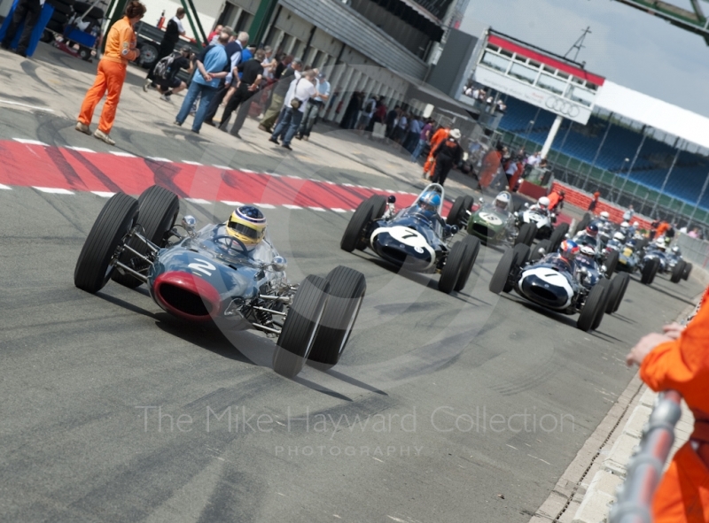 Mark Piecy, Lola Mk4, leads HGPCA pre-1966 cars along the pit lane, Silverstone Classic, 2010