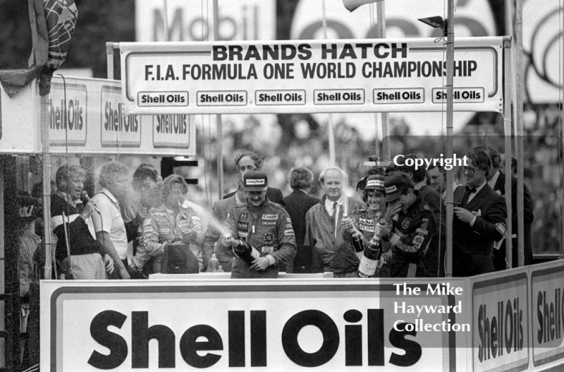 Nigel Mansell, Ayrton Senna Keke Rosberg celebrate on the podium, Brands Hatch, 1985 European Grand Prix. Alain Prost is also on the podium as he won the championship by finishing fourth at this race.
