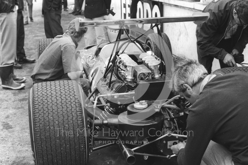 The McLaren Ford M7A driven by Bruce McLaren receives attention during practice for the 1968 British Grand Prix at Brands Hatch.
