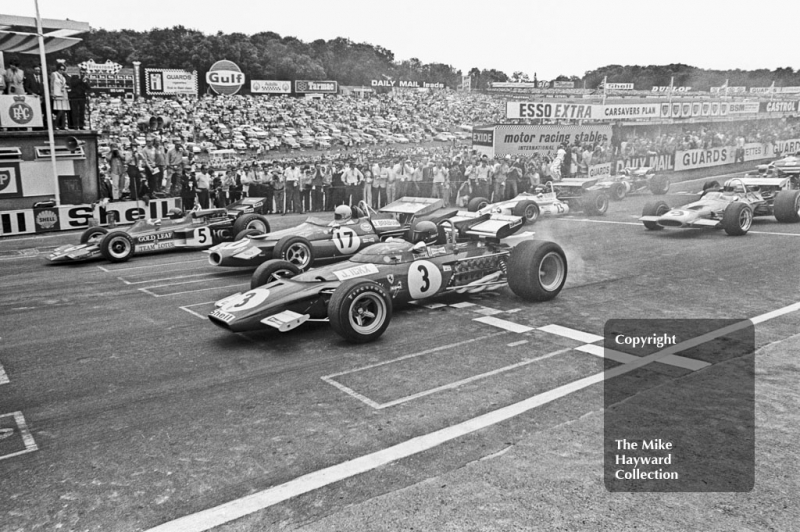 Jacky Ickx, Ferrari 312B, Jack Brabham, Brabham BT33 and Jochen Rindt, Lotus 72C, lead off the grid at the start of the 1970 British Grand Prix at Brands Hatch.
