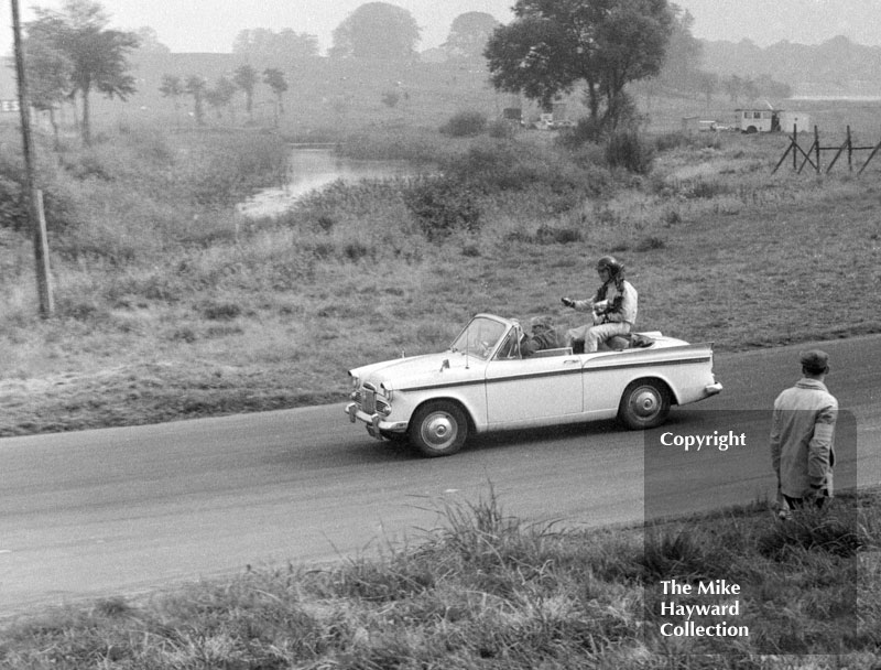 Dan Gurney, Sunbeam Rapier, on this victory lap after winning the saloon car race at the 1963 Gold Cup, Oulton Park.
