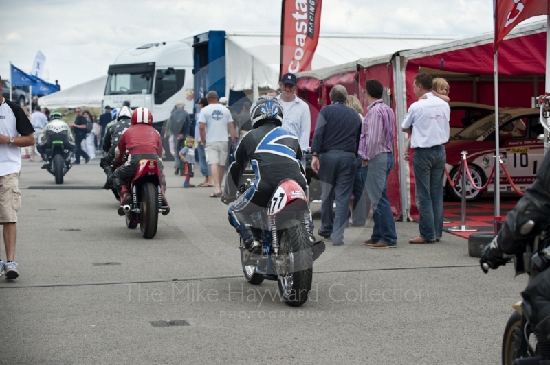 Classic bikes make their way through the paddock, Silverstone Classic, 2010