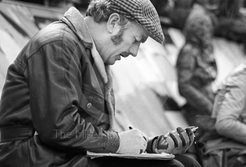 Lotus boss Colin Chapman checks lap times on the pit counter, Silverstone International Trophy 1970.
