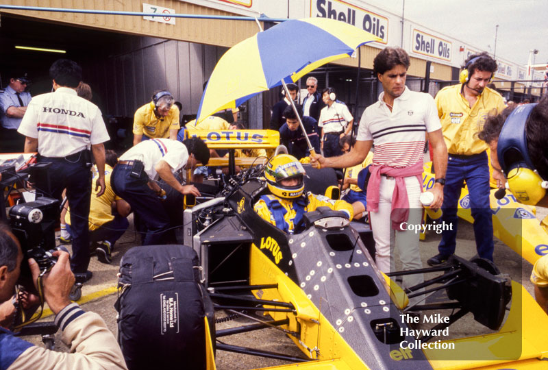 Ayrton Senna, Camel Lotus 99T, in the pits during practice for the 1987 British Grand Prix, Silverstone.
