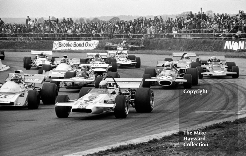 First lap of heat two at copse corner, Silverstone, 1971 International Trophy. Brian Redman, McLaren M18, with Jean-Pierre Beltoise, Matra MS120B, Henri Pescarolo, March 711 and Tim Schenken, Brabham BT33.
