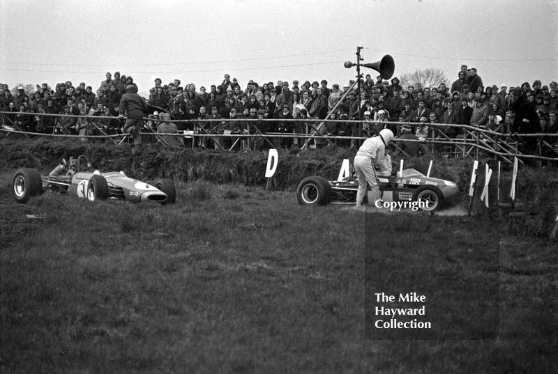 Paul Purseglove is helped out of his Brabham BT28, with Chris Montague's Brabham also out&nbsp;at Copse Corner, Silverstone, during the 1970 International Trophy.
