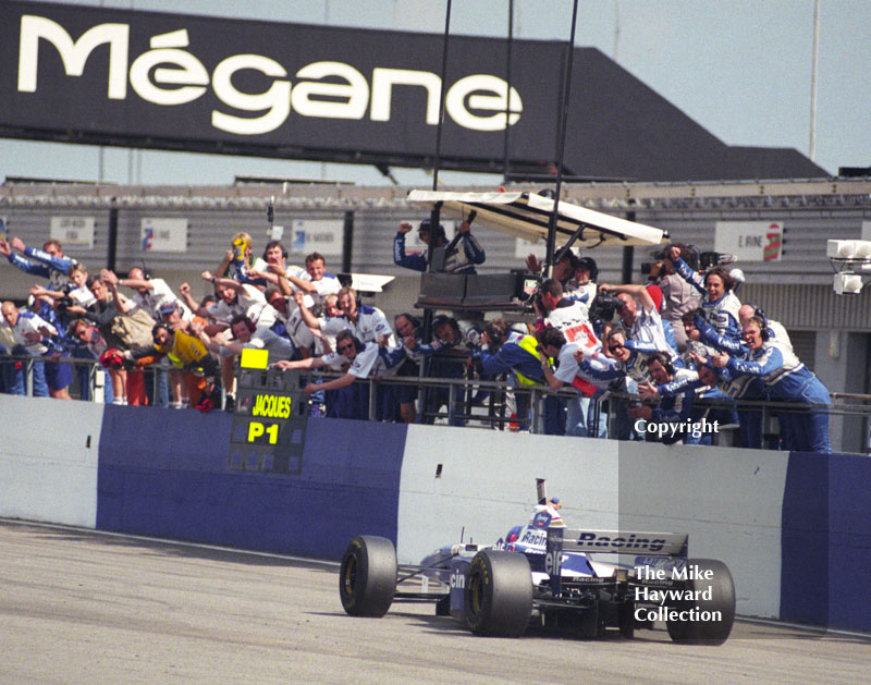 Williams pit crew cheer as Jacques Villeneuve wins with his FW18, Silverstone, British Grand Prix 1996.
