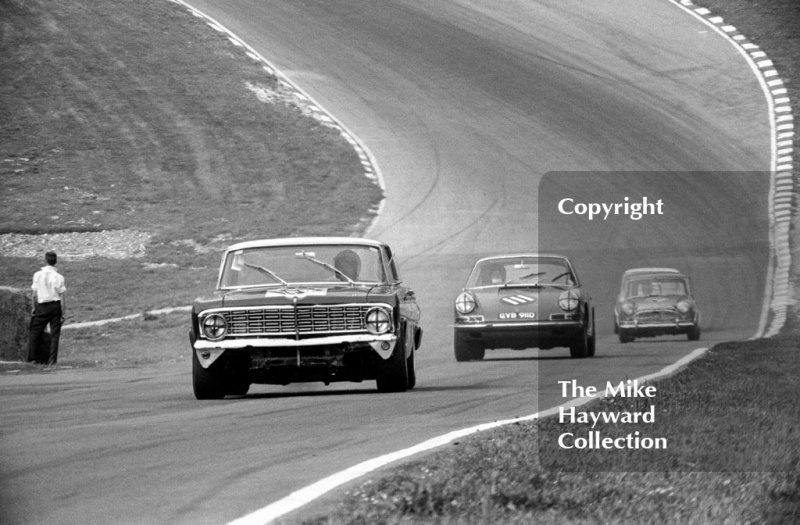 Roy Pierpoint, Ford Falcon, leads Vic Elford, Porsche 911 (reg no GVB 911D), up Pilgrim's Rise, British Touring Car Championship Race, Guards International meeting, Brands Hatch 1967.
