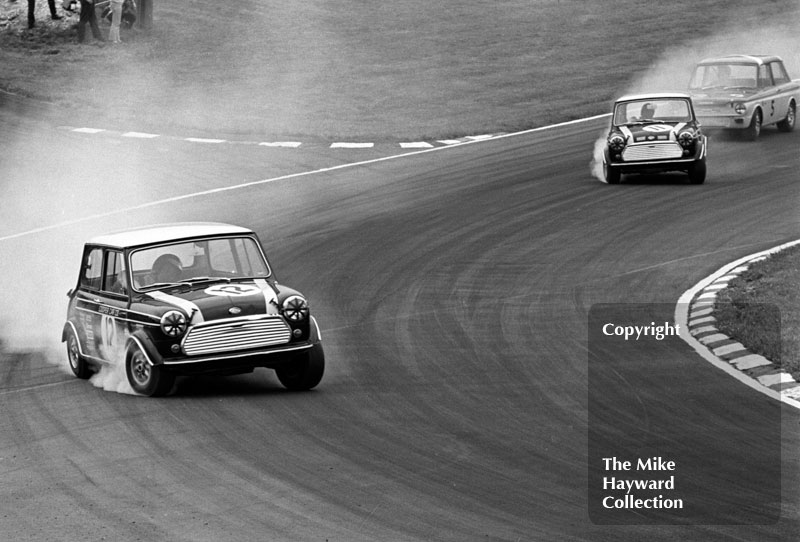 Steve Neal, Cooper Car Company Mini Cooper S,&nbsp;John Rhodes, Cooper Car Company Mini Cooper S, Tony Lanfranchi, Hillman Imp, at South Bank Bend, Brands Hatch, Grand Prix meeting 1968.
