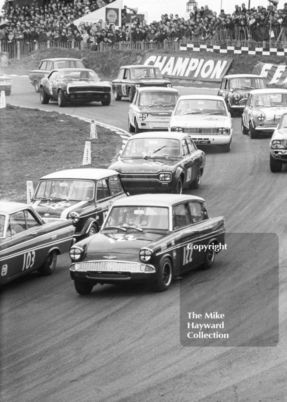 First lap at Paddock Bend with Chris Craft, Broadspeed Ford Anglia leading John Rhodes, Cooper Car Company Mini Cooper S, John Fitzpatrick, Broadspeed Ford Anglia, Brian Robinson, Lotus Cortina, Race of Champions, Brands Hatch, 1968

