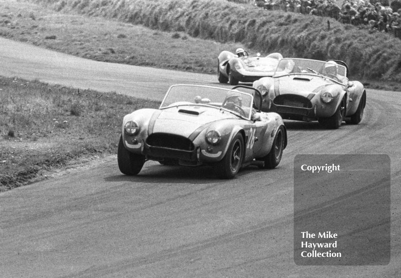 C McLaren, Shelby Cobra, followed by J M Sparrow, Shelby Cobra and John Surtees, Lola T70, at Knickerbrook, Tourist Trophy, Oulton Park, 1965.
