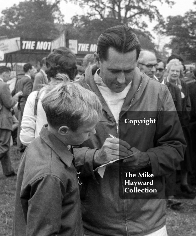 Jack Brabham signs autographs in the paddock, Oulton Park Gold Cup 1962.
