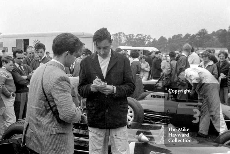 Roy Salvadori signing an autograph, 1962 Gold Cup, Oulton Park.
