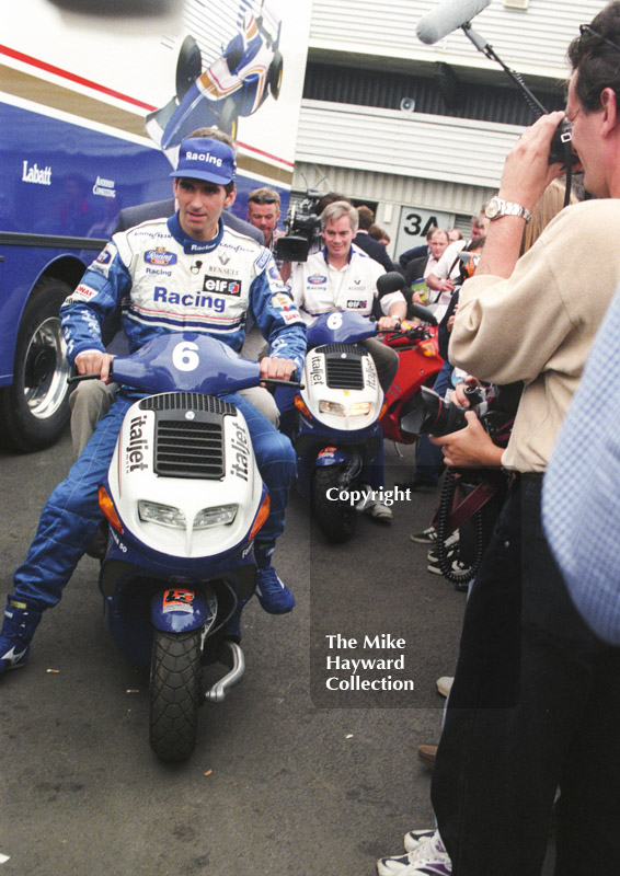 Damon Hill scoots round the paddock, Silverstone, British Grand Prix 1996.
