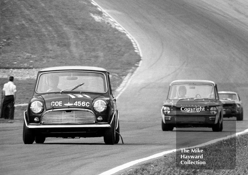 Bill Shaw, Mini Cooper S (reg no COE 456C), leads Tony Lanfranchi, Fraser Hillman Imp, and B Thomson, Ford Mustang, up Pilgrim's Rise, British Touring Car Championship Race, Guards International meeting, Brands Hatch 1967.
