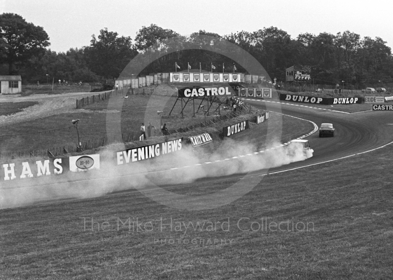 John Rhodes, Cooper Car Company Mini Cooper S, smokes through South Bank Bend, Brands Hatch, Grand Prix meeting 1968.
