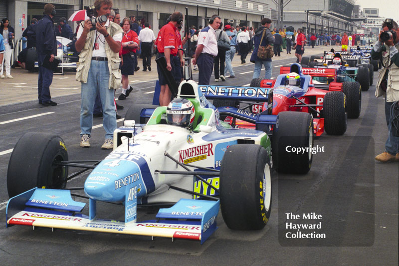 Gerhard Berger, Benetton Renault B196, heads the queue out of the pit lane, Silverstone, British Grand Prix 1996.
