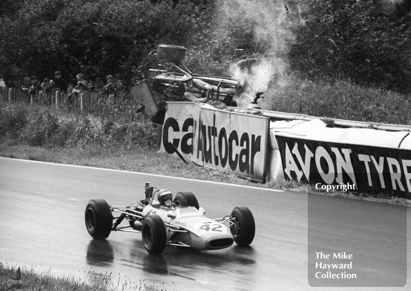 Peter Gaydon, SMRT Titan MK 3 Ford, takes off over an Autocar sign, Mallory Park, Guards International Trophy, 1968. Also seen is Reine Wisell, Team Baltzar Tecno 68 Ford.
