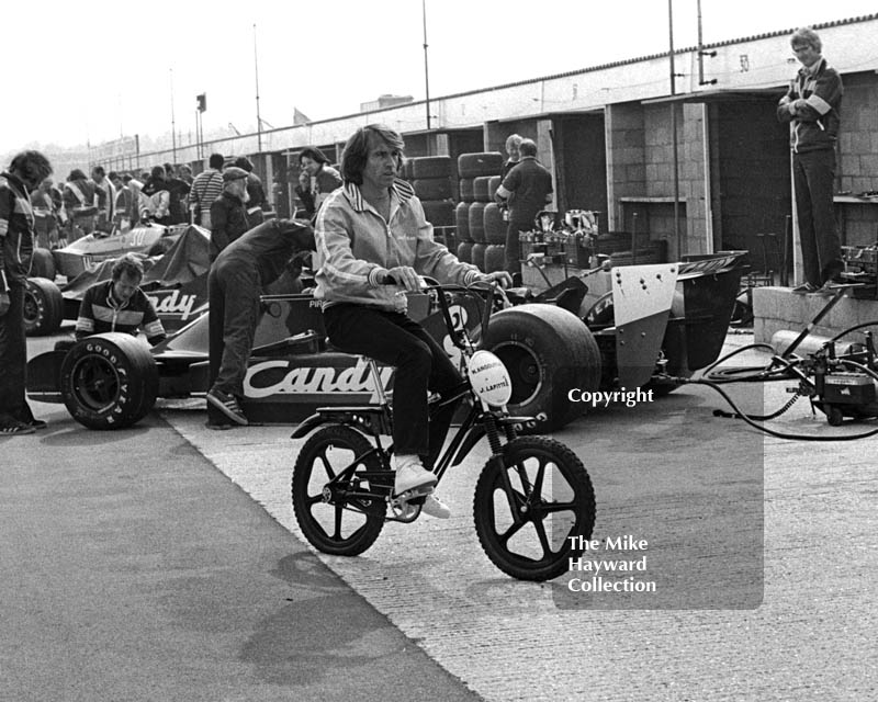 Jacques Laffite cycling in the pit lane, Silverstone, British Grand Prix 1979.
