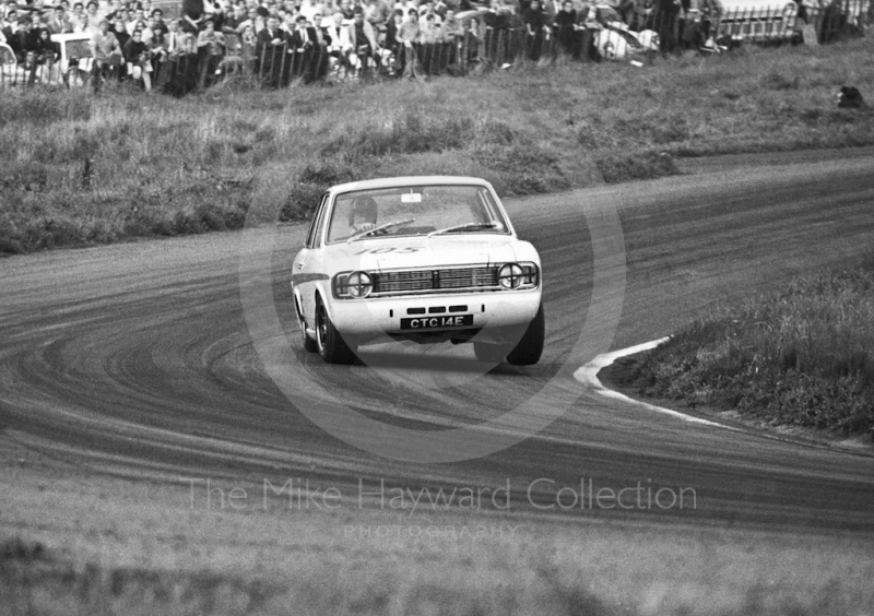 Graham Hill, Team Lotus Cortina, CTC 14E, at Cascades Bend before retiring, having set fastest lap in Class A of 89.22mph, Oulton Park Gold Cup meeting, 1967.
