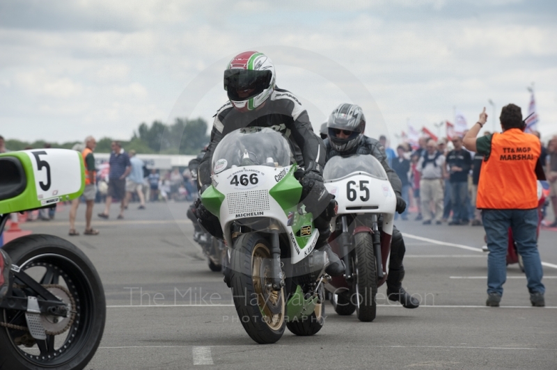 Riders wait to take their classic bikes out on to the circuit, Silverstone Classic, 2010