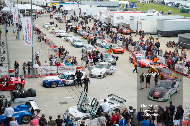 Sports cars lined up in the paddock at the 2016 Silverstone Classic.
