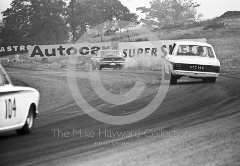 Graham Hill, Team Lotus Cortina, CTC 14E, chases a Ford Falcon out of Cascades followed by the Lotus Cortina of William Vaughan, Oulton Park Gold Cup meeting, 1967.
