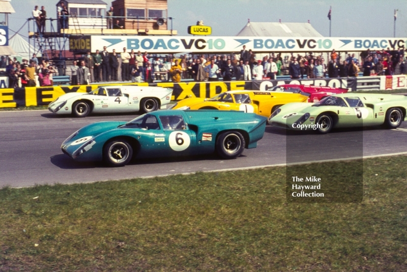 Leaving the grid at the start of the race are Trevor Taylor, Team Elite Lola T70; Brian Redman, Sid Taylor Lola T70; Jo Bonnier, Lola T70; and Frank Gardner, Grand Bahama Racing Lola T70, Wills Embassy Trophy Race, Thruxton, Easter Monday 1969.
