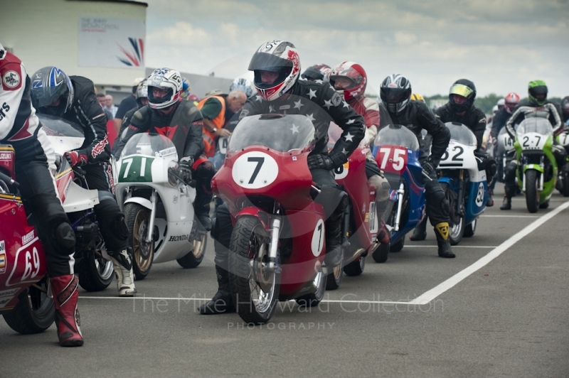 Classic bikes wait to go out on the circuit, Silverstone Classic, 2010