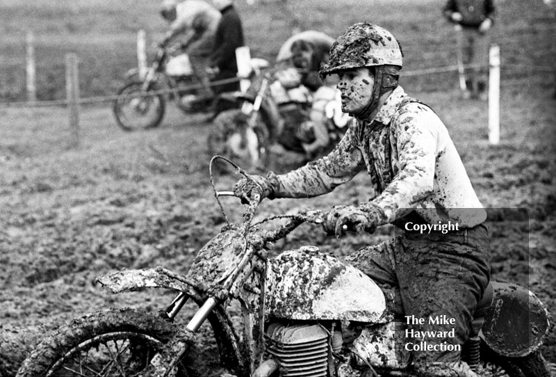 Mud-covered rider, Hatherton Hall Farm motocross, Nantwich, 1967
