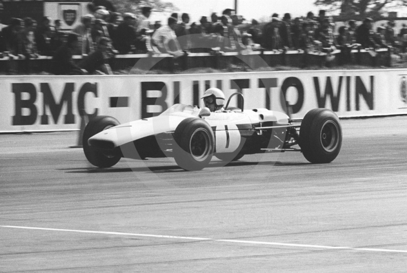 Chris Irwin, Chequered Flag Brabham BT18, at Woodcote Corner on the way to 2nd place, Radio London Trophy, Silverstone, 1966.
