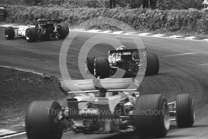 Denny Hulme, Mclaren M14D, and Clay Regazzoni, Ferrari 312B, follow a BRM through Stirling's Bend, British Grand Prix, Brands Hatch, 1970
