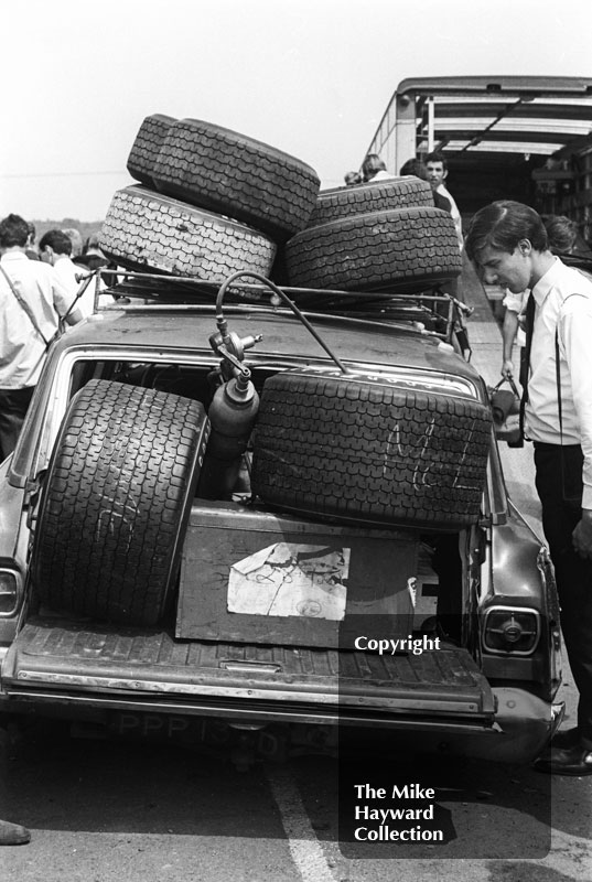 A spectator marvels at the size of racing tyres in the paddock, Brands Hatch, 1968 Grand Prix.
