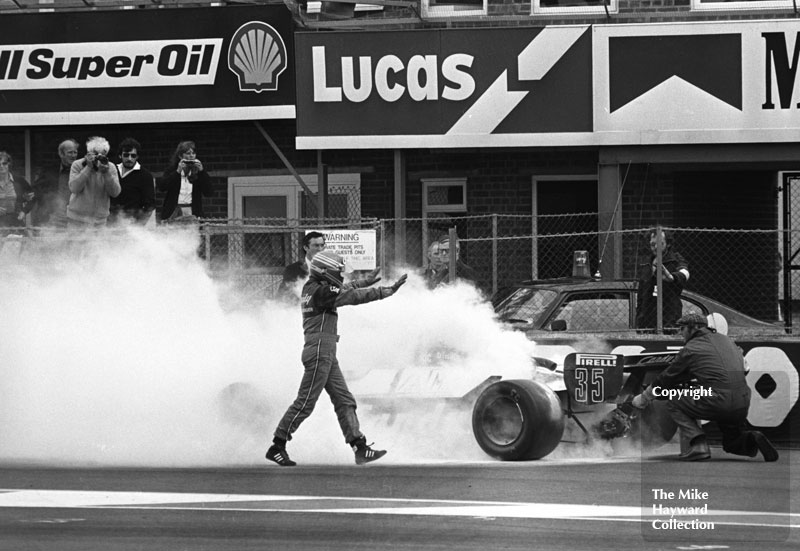 Brian Henton gestures to marshalls as they use fire extinguishers on his Toleman TG181 during practice for the 1981 British Grand Prix at Silverstone.
