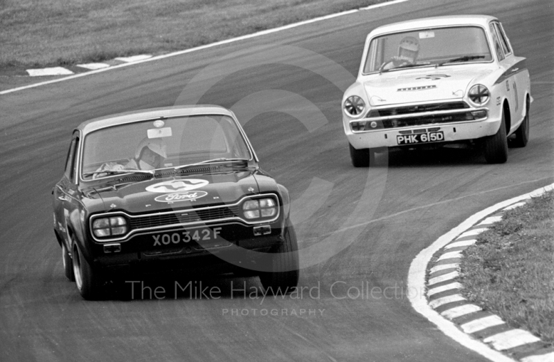 John Fitzpatrick, Broadspeed Ford Escort, reg no XOO 342F, followed by Barry Pearson,&nbsp;Lotus Cortina, reg no PHK 615D, at South Bank Bend, British Saloon Car Championship race, 1968 Grand Prix meeting, Brands Hatch.
