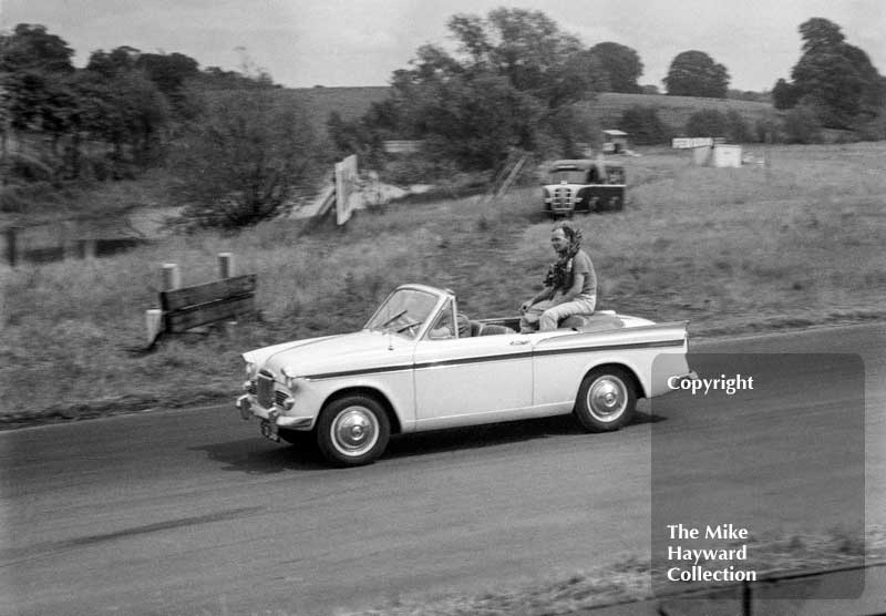 Innes Ireland on his victory lap in a Sunbeam Rapier Convertible after winning the 1962 Oulton Park Gold Cup in a Lotus 19.
