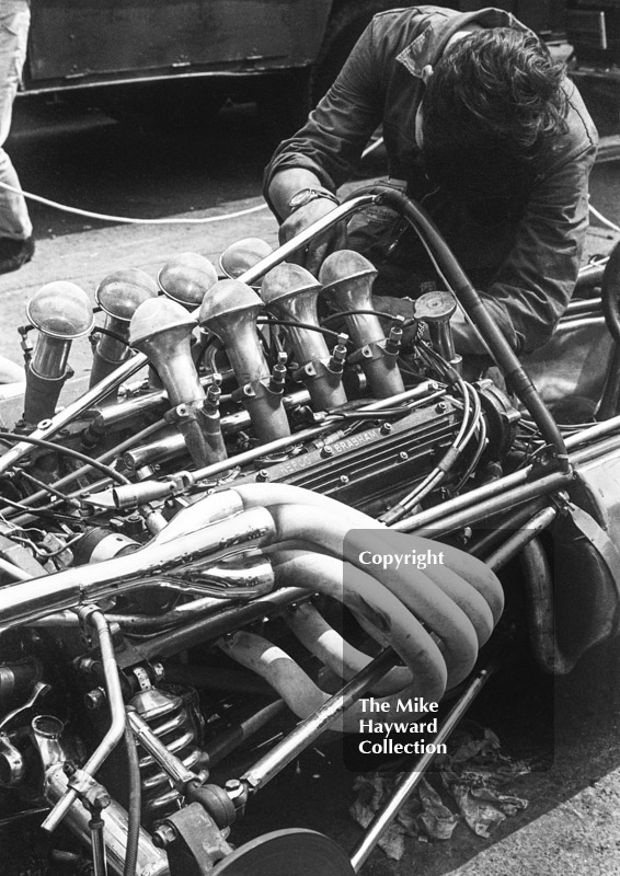 Mechanic at work on a Formula One Repco Brabham engine in the paddock, Brands Hatch, 1968 British Grand Prix.
