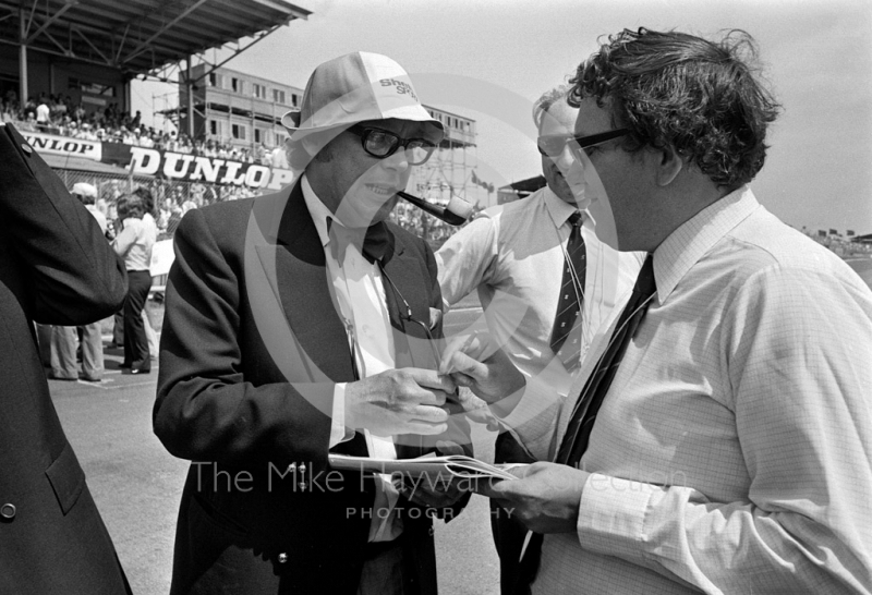 Eric Morecambe signing autographs, Brands Hatch, British Grand Prix 1974.
